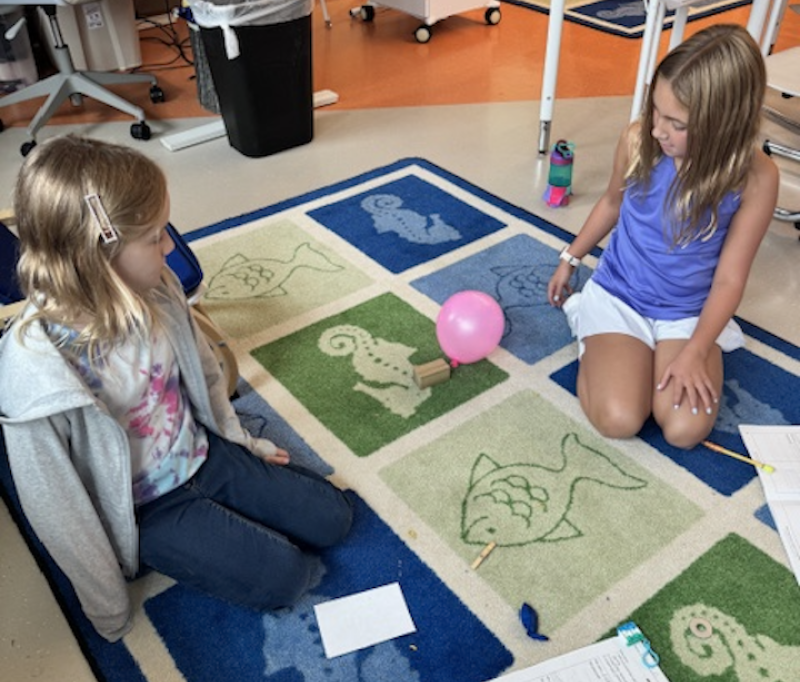 Rehoboth Elementary School students Maddie Gomez, left, and Brinnleigh McHugh explore how to move objects without touching them. SUBMITTED PHOTOS